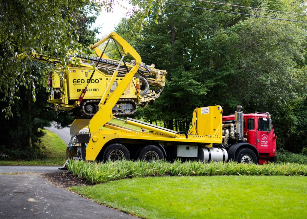 Truck delivering the drilling rig and dumpster - Residential geothermal