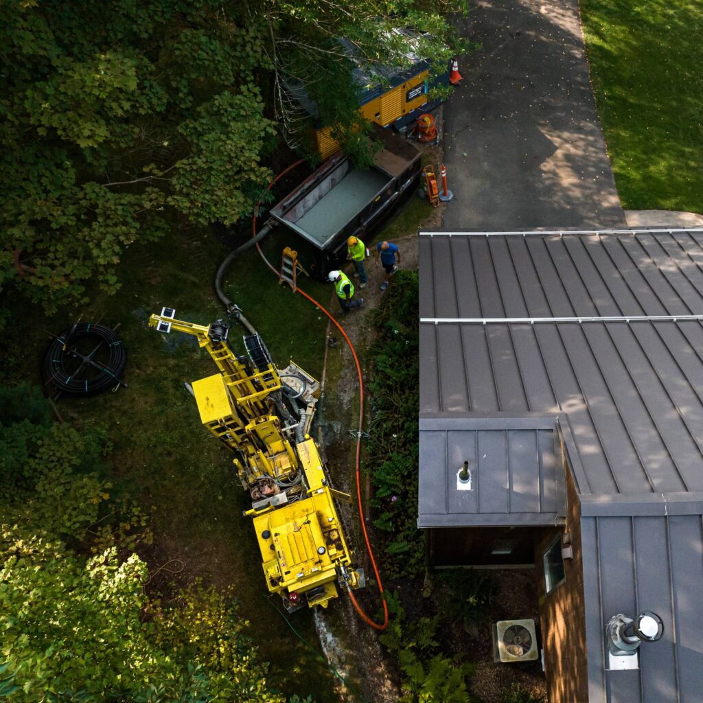 Image of equipment out of the homeowner's driveway for residential geothermal